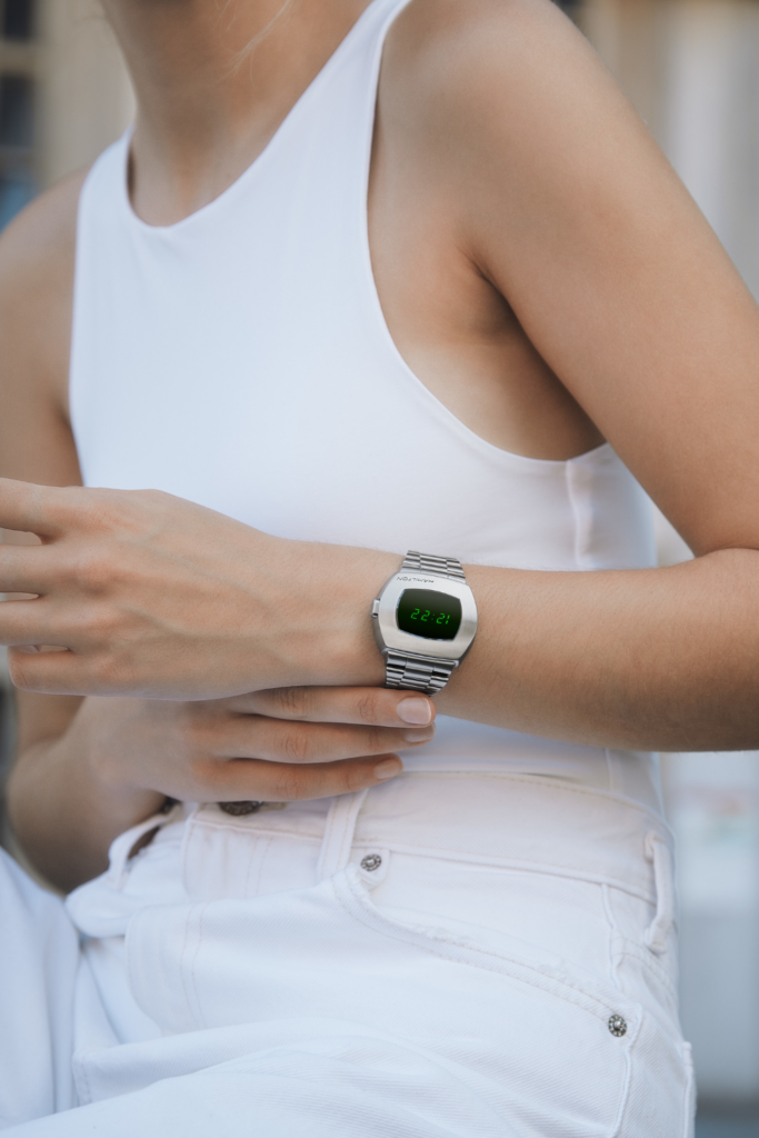 Close-up of woman's arm wearing Hamilton digital watch.