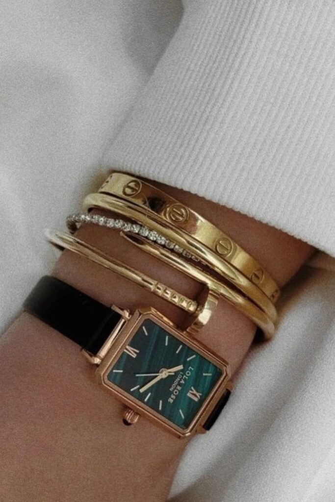 Photo showing a woman's wrist with a Lola Rose watch and several bracelets including a tennis bracelet.